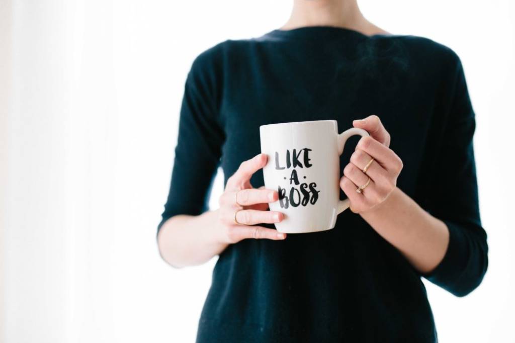 Woman holding cup with slogan Like a boss